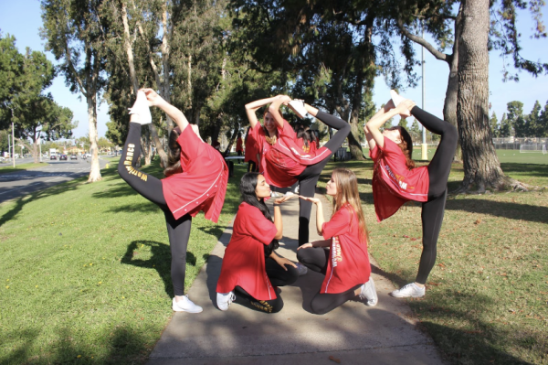 The varsity dance team displays the iconic scorpian pose, showing off their flexibility and strength.